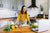 Woman waiting for instruction from her online cooking class.